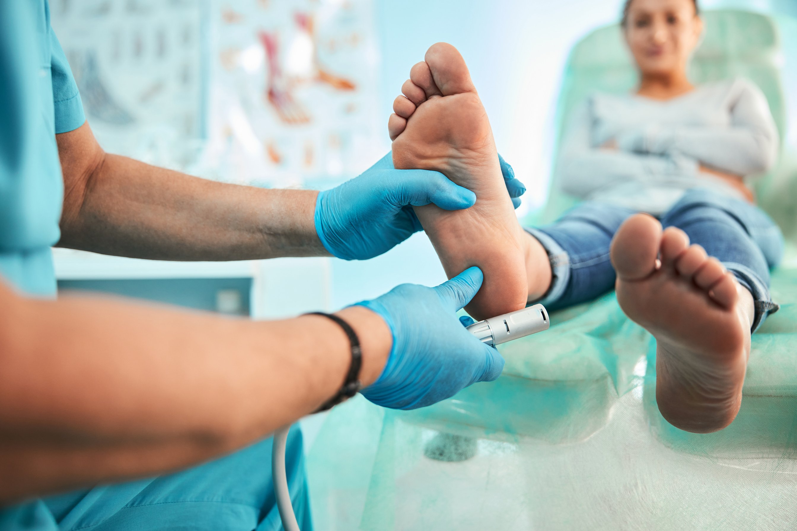 Podiatrist using special grinding equipment and making procedure polish for feet